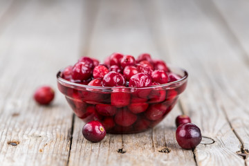 Some fresh Cranberries (preserved) (selective focus; close-up shot)