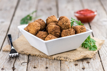 Vintage wooden table with Meatballs (selective focus; close-up shot)