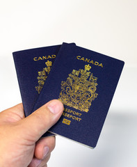hand holding two Canadian passports