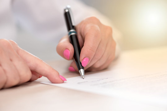 Woman signing a contract, light effect