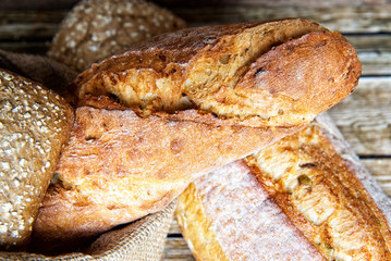 Freshly baked homemade bread on rustic wooden background.