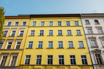 Fototapeta na wymiar yellow facade of apartment building in low angle view