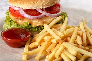 Fresh cheeseburger with French fries and tomato sauce