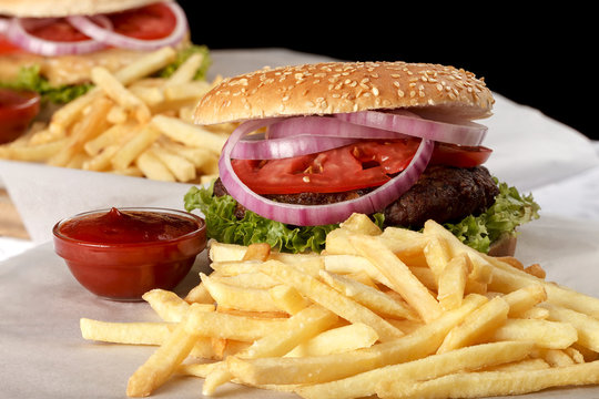 Fresh hamburger with French fries and tomato sauce