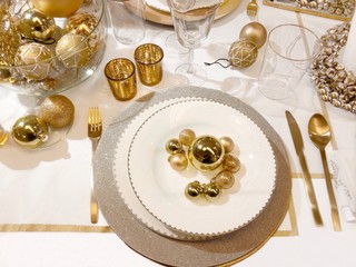 Beautiful table setting with Christmas decoration in golden color
