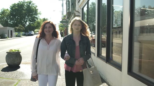 Tracking shot of two women entering a shop