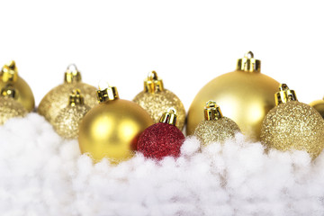 Branch of Christmas tree with short needles decorated toys isolated on white background.