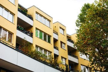 yellow apartment complex with tree