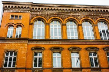 Fototapeta na wymiar historical brick building with curved windows