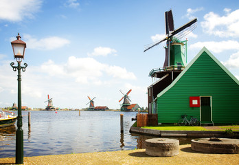 dutch windmills over river in Zaanse Schans in sunny day, Netherlands, retro toned