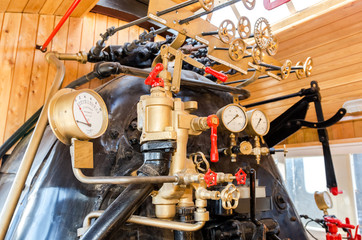 Fototapeta na wymiar Retro steam locomotive boiler with engineering equipment