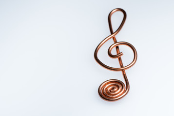 A treble clef made of bent copper wire