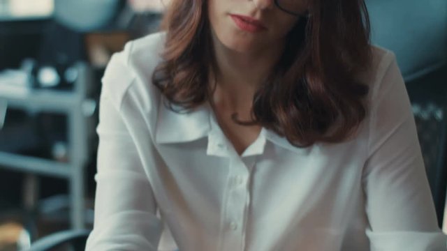 Close-up of a beautiful woman's face sitting at the desk writing in the office screen tablet coworking girl technology business female internet attractive standing startup worker Slow Motion Shot
