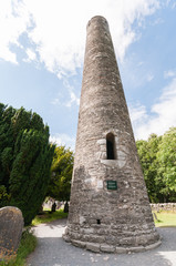 Fototapeta premium Ancient monastic Roundtower at Glendalough Graveyard, Ireland