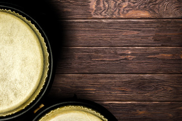 Drums bongos on the brown wooden background