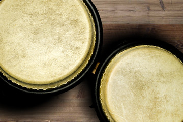 Drums bongos on the brown wooden background