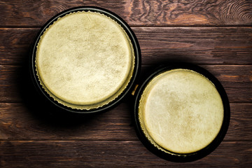 Drums bongos on the brown wooden background