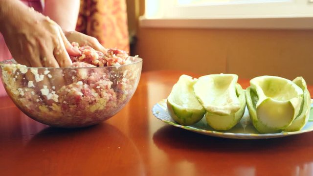 women's hands preparing zucchini stuffed with minced meat and Bulgarian peppers. 4k, slow-motion, close-up