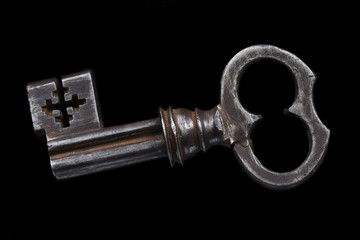 Beautiful vintage metal key on black background