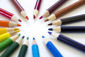 Close up of color pencils pointed making a circle
