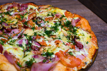 pizza with ham and cheese on a board
