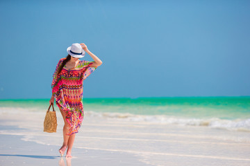 Young woman in hat during tropical beach vacation