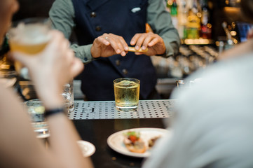 Barman making an alcoholic cocktail at the bar