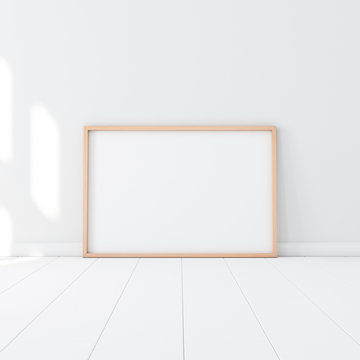 Horizontal Wooden Poster Frame Mockup standing on the white floor in empty room. 3d rendering