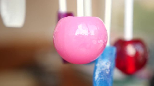 colorful lollipops hang in the air. 4k slow motion