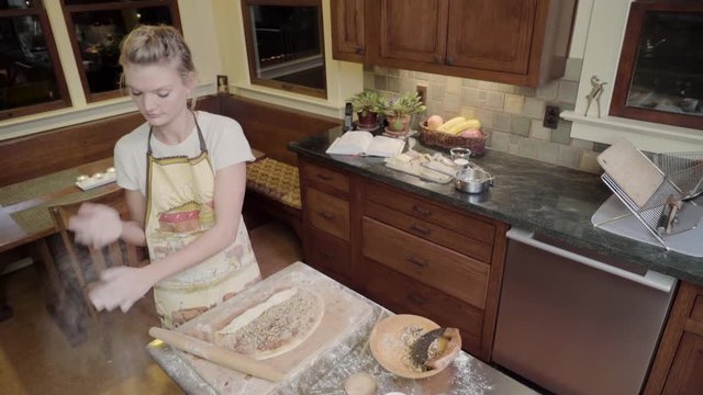 Medium shot of a baking woman taking a phone call