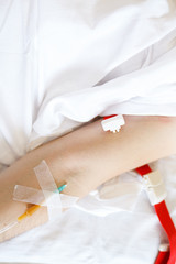 Hand of a sick person with a needle for injection