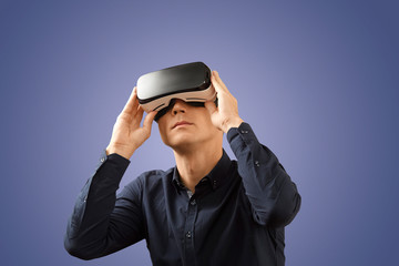 Smartphone using with VR glasses. Man wearing virtual reality glasses. Virtual reality today.