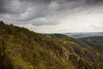 Fototapeta premium Cloudy sky over autumn forest