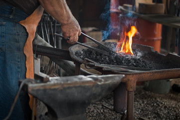 Blacksmith Heats Work in Fire