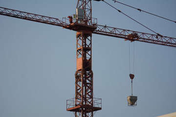 Fototapeta na wymiar red crane with a weight hanged on it