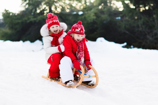 Kids On Sleigh. Children Sled. Winter Snow Fun.