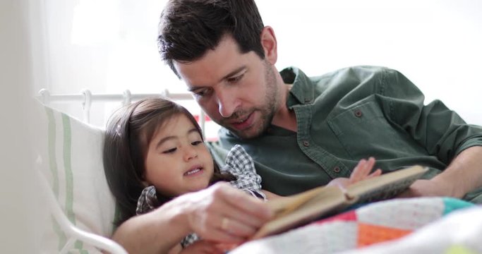 Father reading Daughter a bedtime story