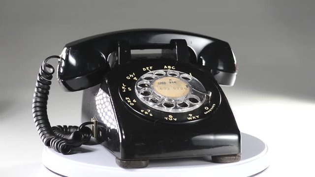 Old style black telephone rotating.