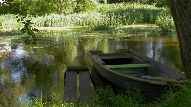 A Wooden Boat At The Pier On Pond