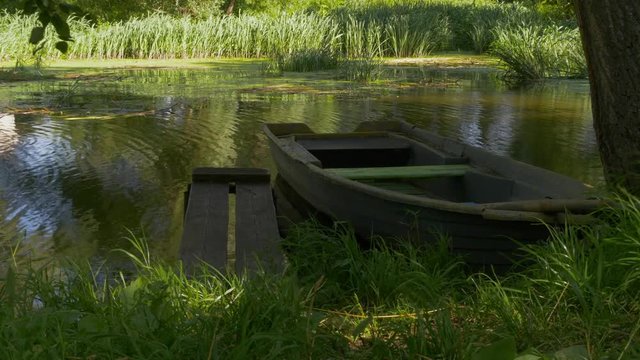 A Wooden Boat At The Pier On Pond