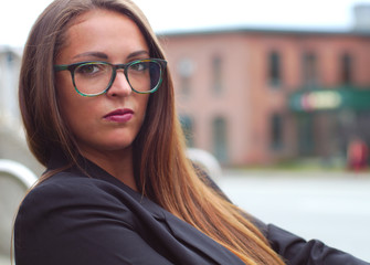 young businesswoman outside glasses profile portrait
