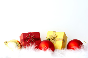 Christmas ball red, gold color and gift box with white feather on white background, Copy space for your text