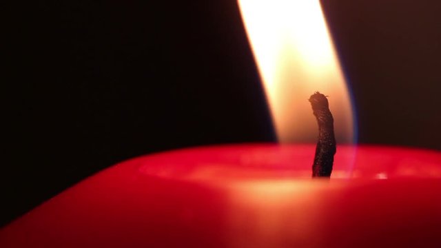 burning red wax candle. macro shooting