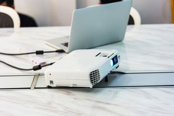projector connected to Laptop on for presentation in a meeting room