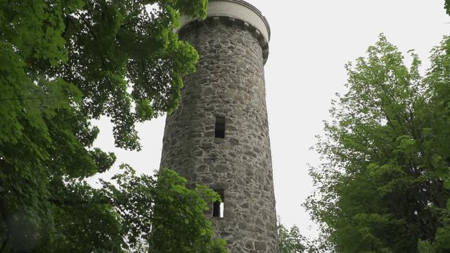 The Hamelika View Tower in forest. Rainy day. Tilt down..