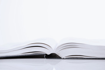 Open book on white background as a symbol of love for literature and knowledge.