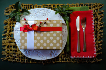 Polka dot Christmas gift holiday dinner background with holly and berries
