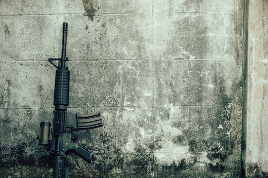 M4A1 (AR-15), M-16 assault rifle gun for the American military is placed beside the old wall.