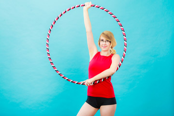 Fit woman with hula hoop doing exercise © anetlanda