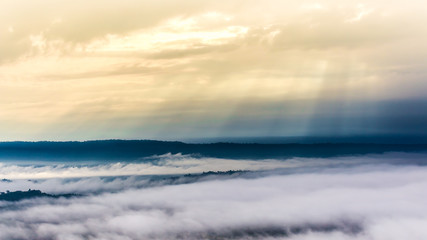 Fototapeta na wymiar Mountain in morning sun ray and winter fog